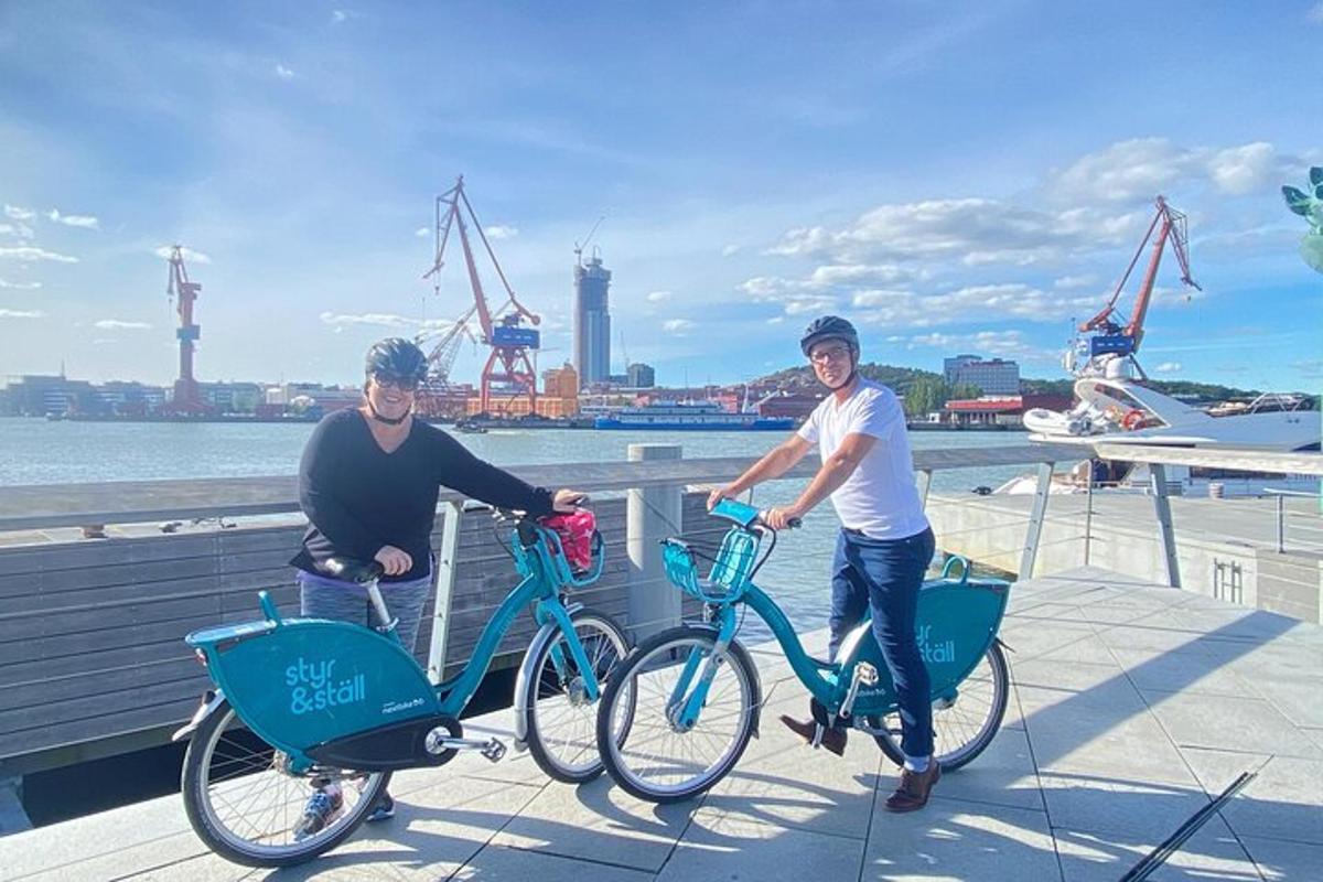 a man and a woman standing with their bikes