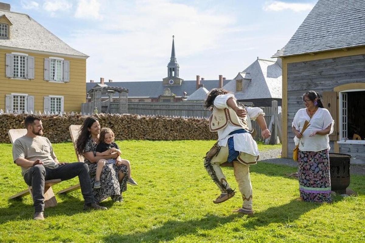 a group of people sitting in the grass with a woman dancing