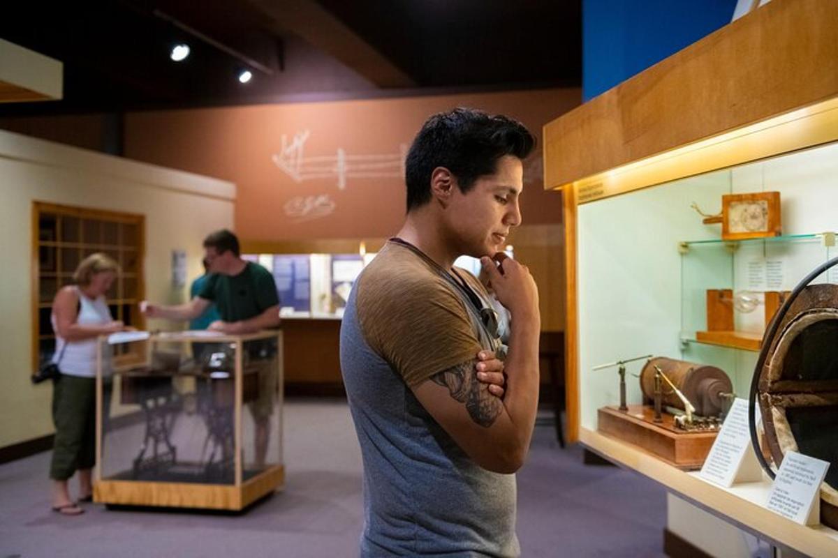 a man with a tattoo talking on a cell phone in a store