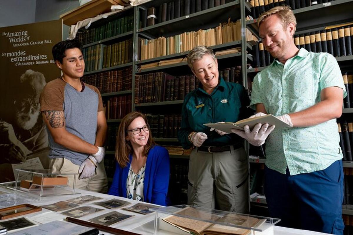 a group of people standing around a table in a library
