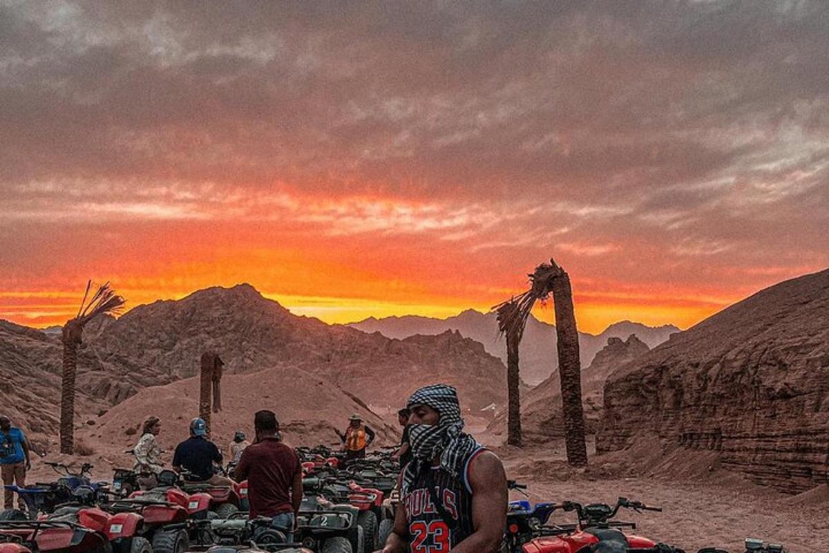 a group of motorcycles parked in the desert at sunset