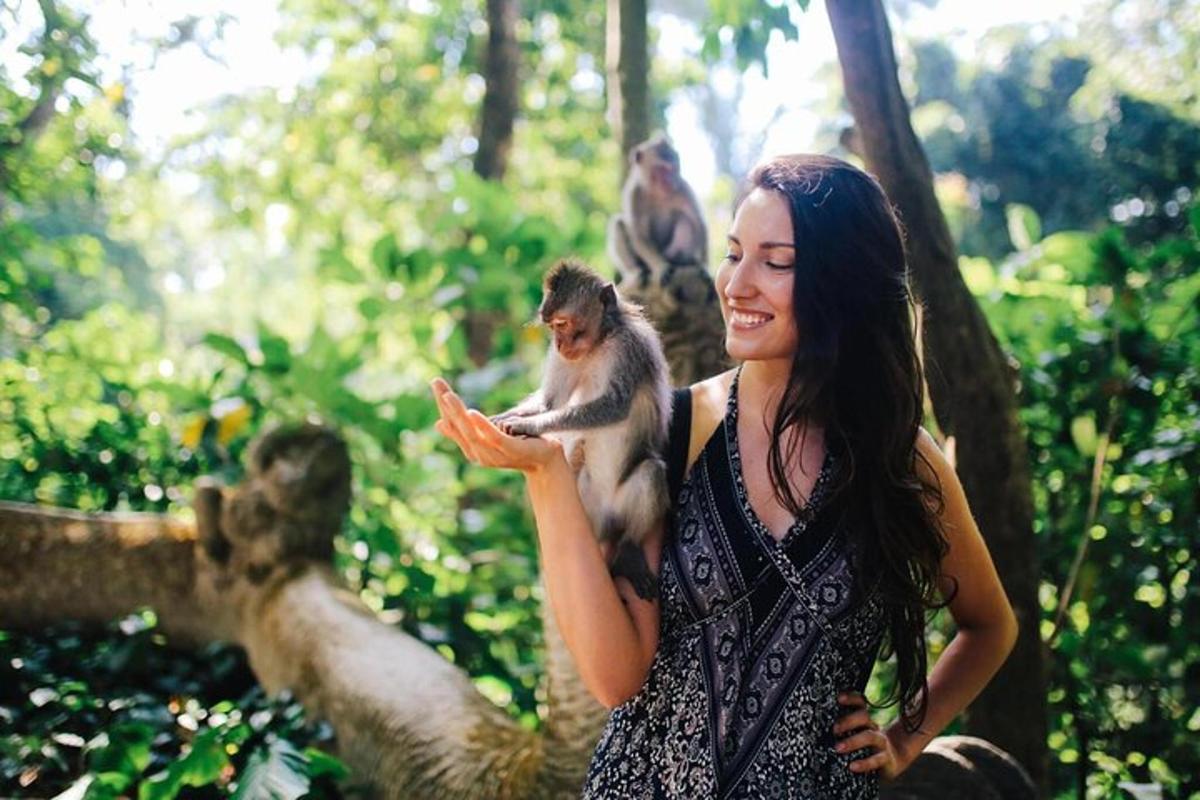 a woman holding a monkey in her hand
