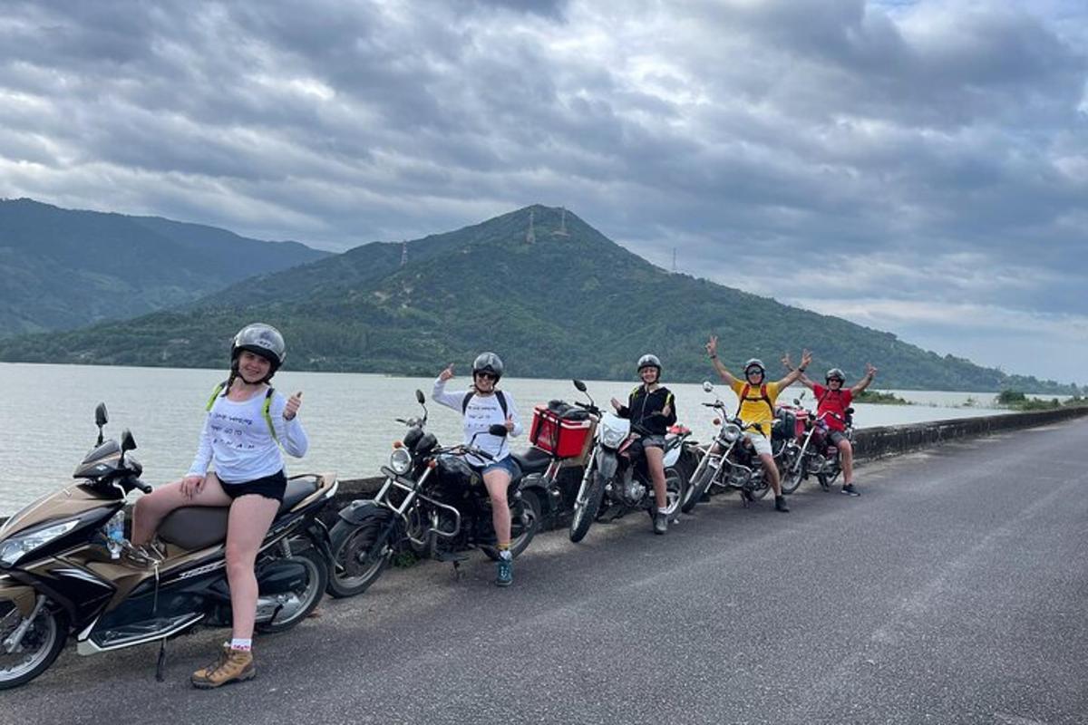 a group of people riding motorcycles on a road