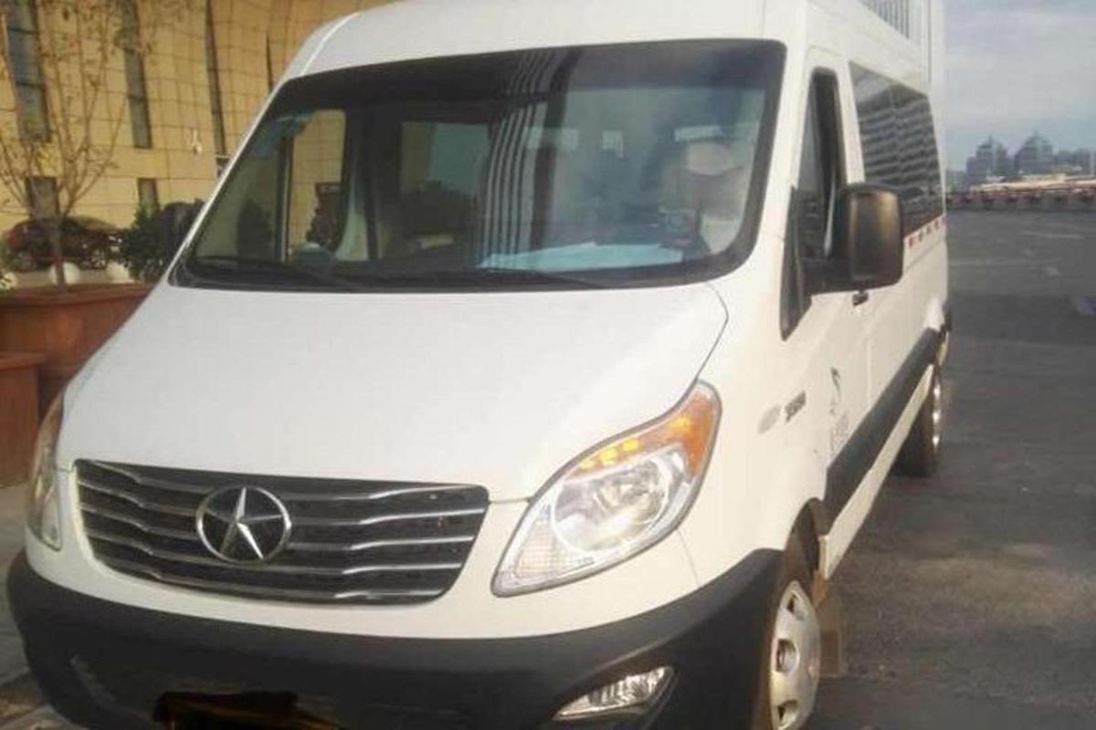 sebuah mobil van putih diparkir di tempat parkir