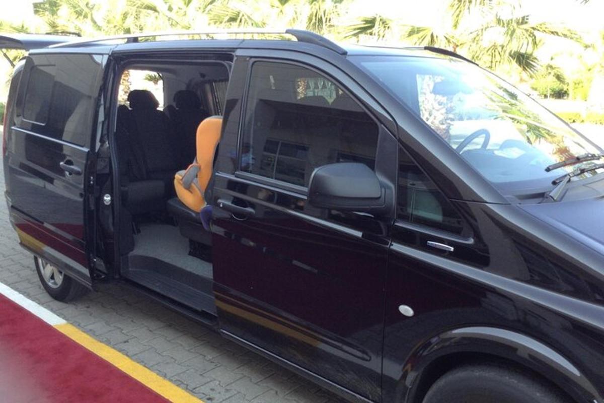 a black van parked in a parking lot with its door open