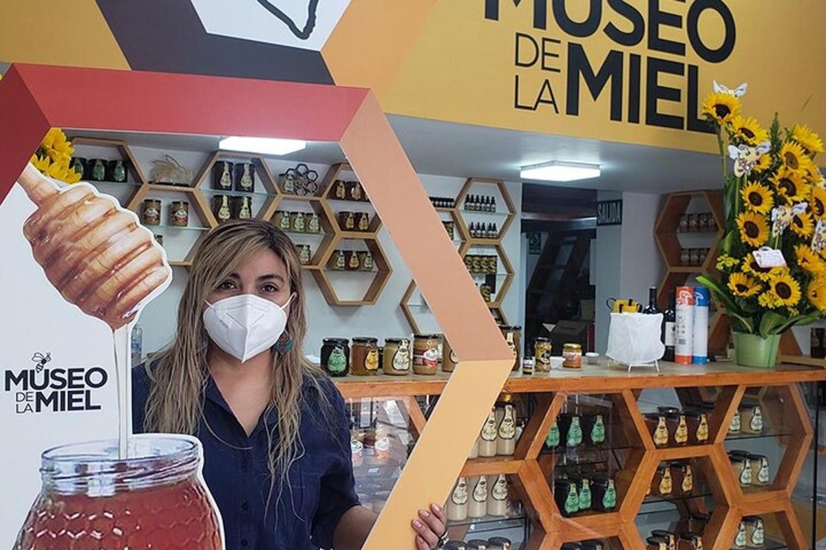una donna che indossa una maschera e tiene in mano un barattolo di limonata Moose Degné