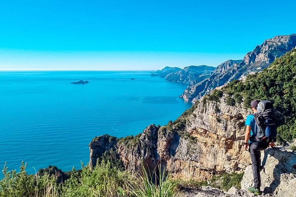 muž a žena stojící na útesu s výhledem na oceán