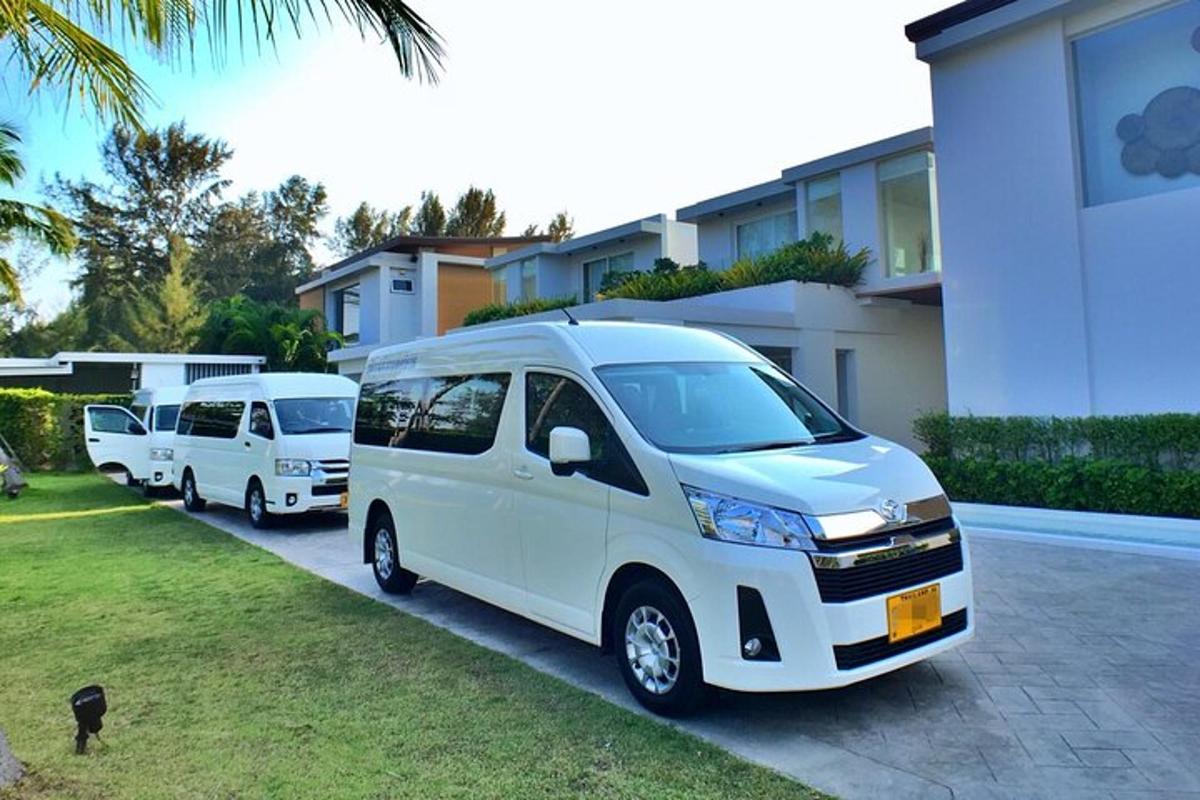 a row of white vans parked in a parking lot
