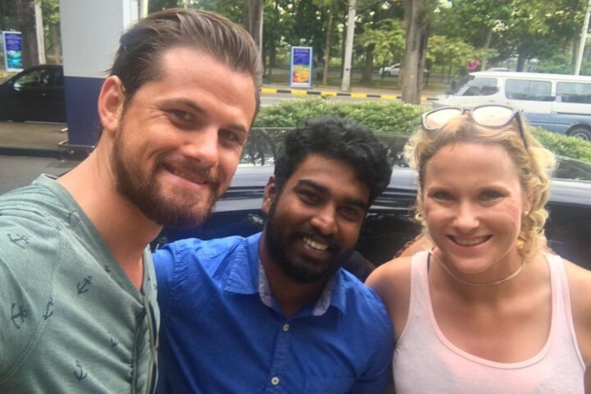 two men and a woman posing for a picture