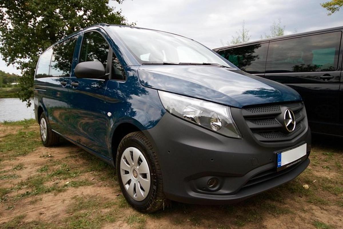 un'auto blu parcheggiata accanto a un furgone