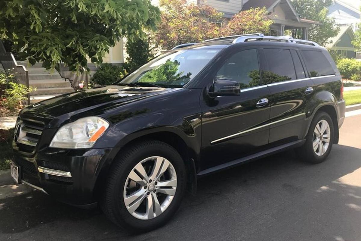 a black suv parked in front of a house