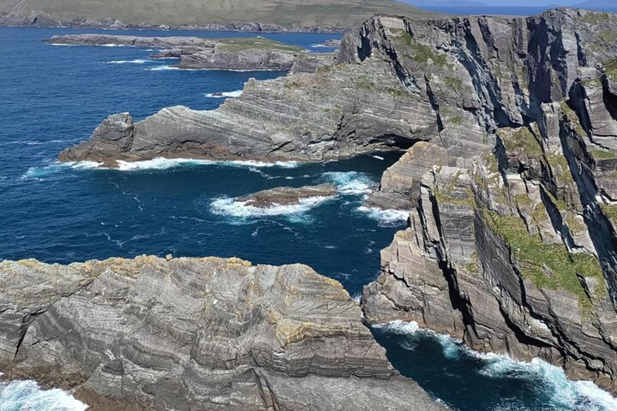 an aerial view of the ocean and rocky coastline