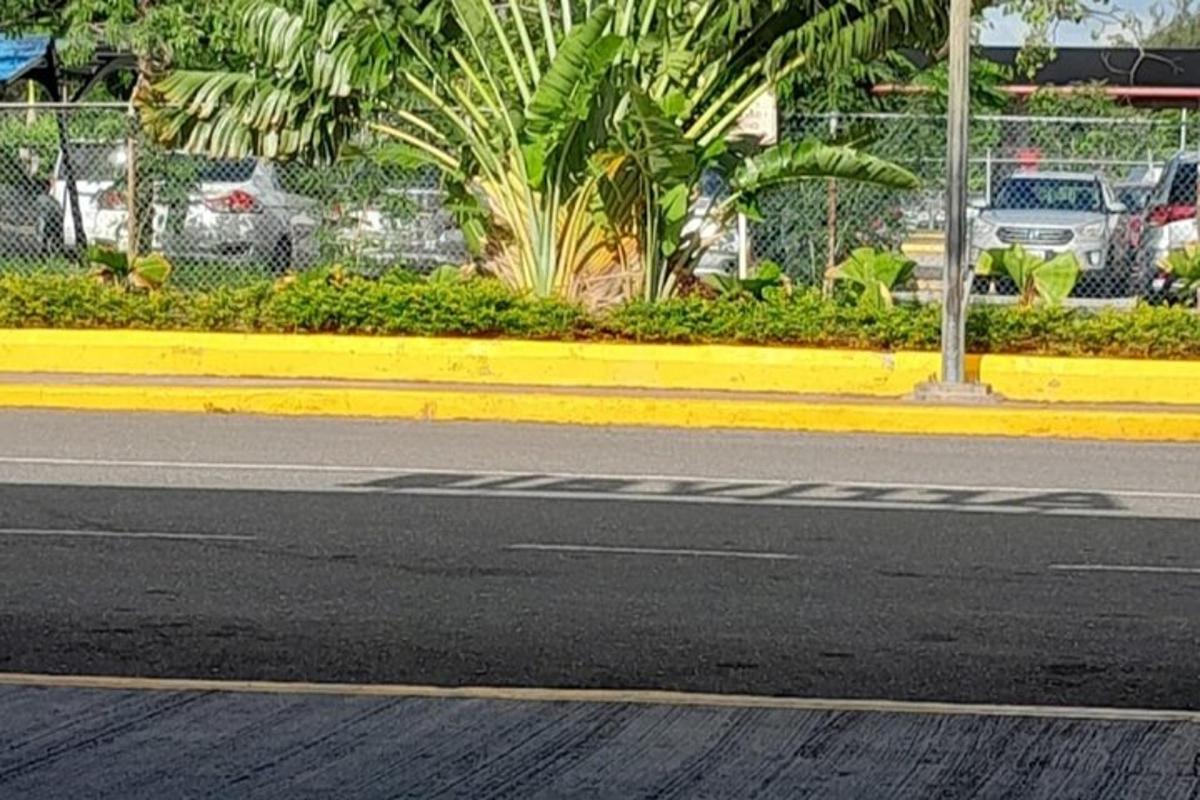 a street with a yellow curb on the side of a road