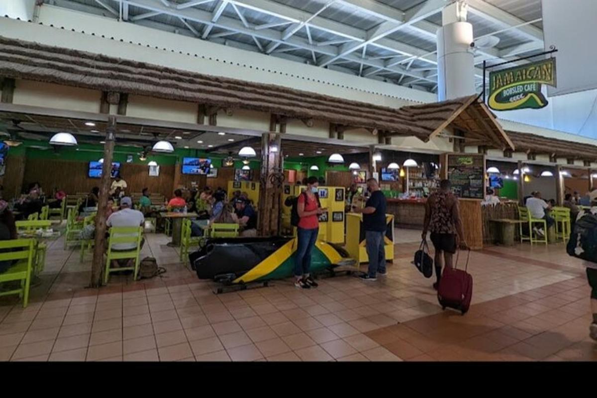 a group of people standing in an airport with luggage