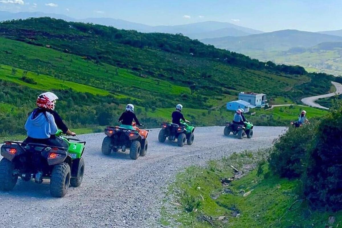 a group of people riding on atvs on a road