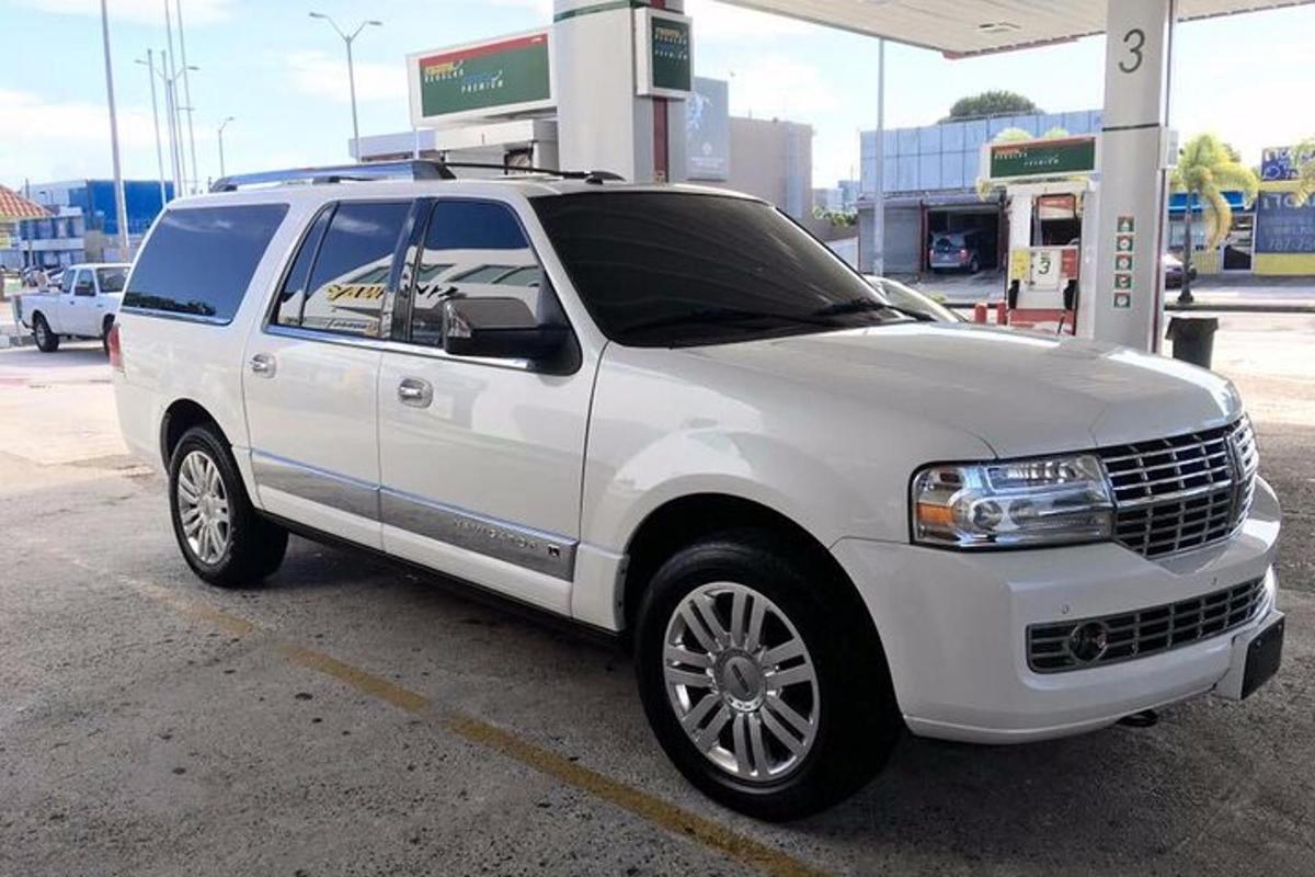a white suv parked at a gas station