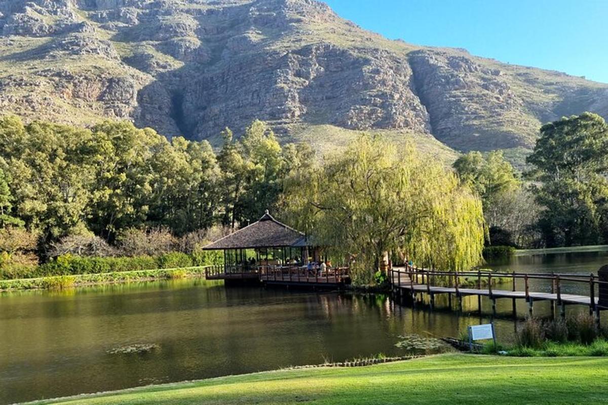 a gazebo in the middle of a lake with a mountain