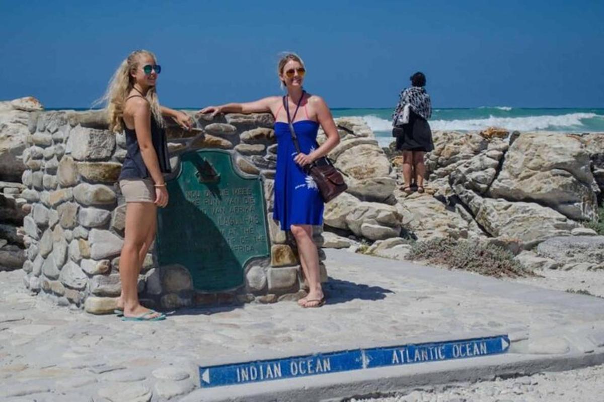 due persone in piedi accanto a un cartello sulla spiaggia