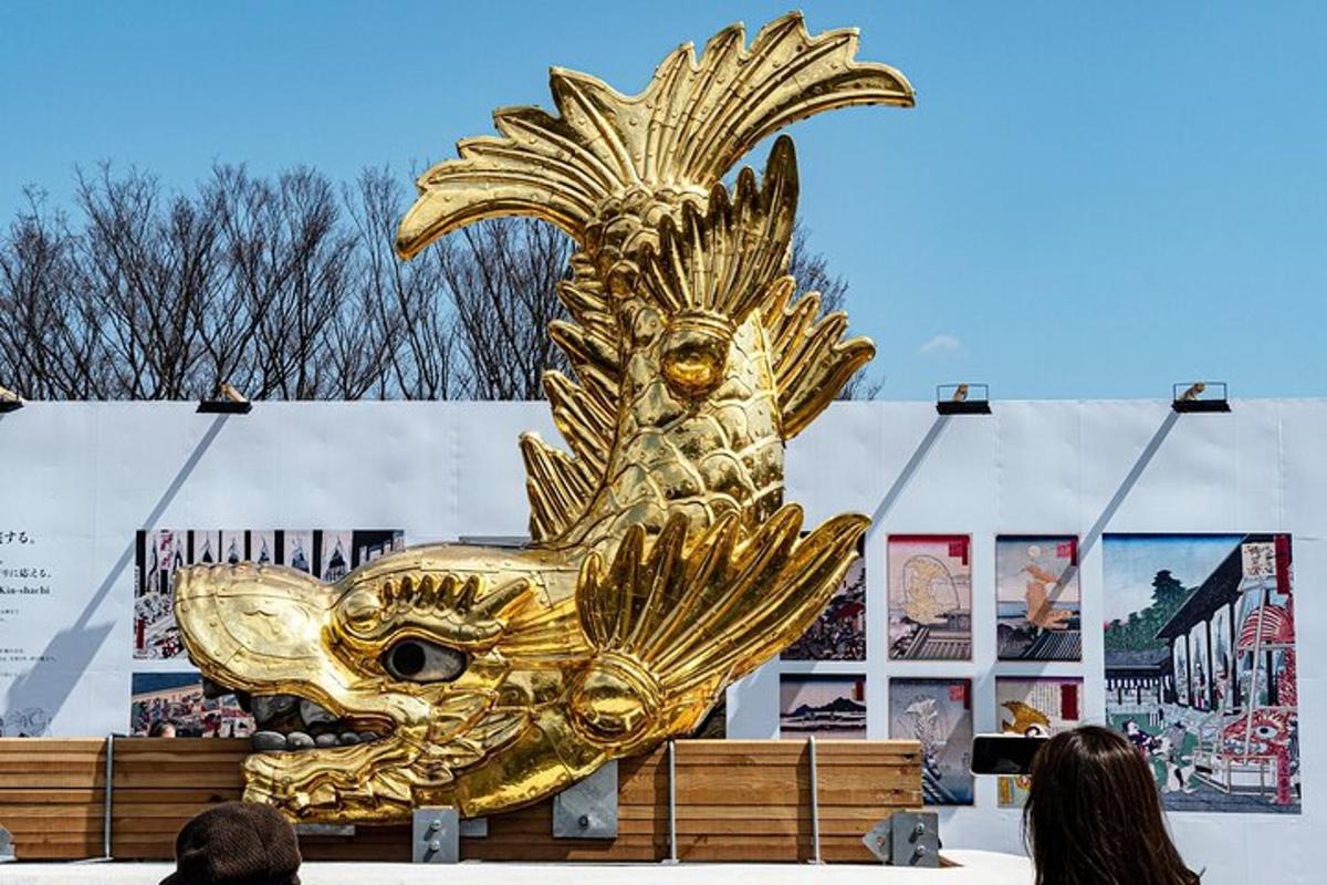 a large golden peacock statue in front of a building