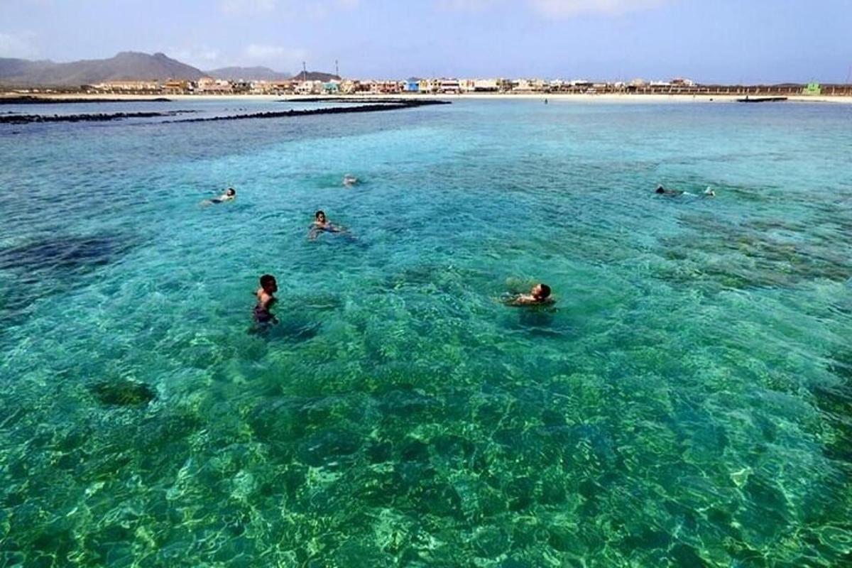 a group of people swimming in the ocean