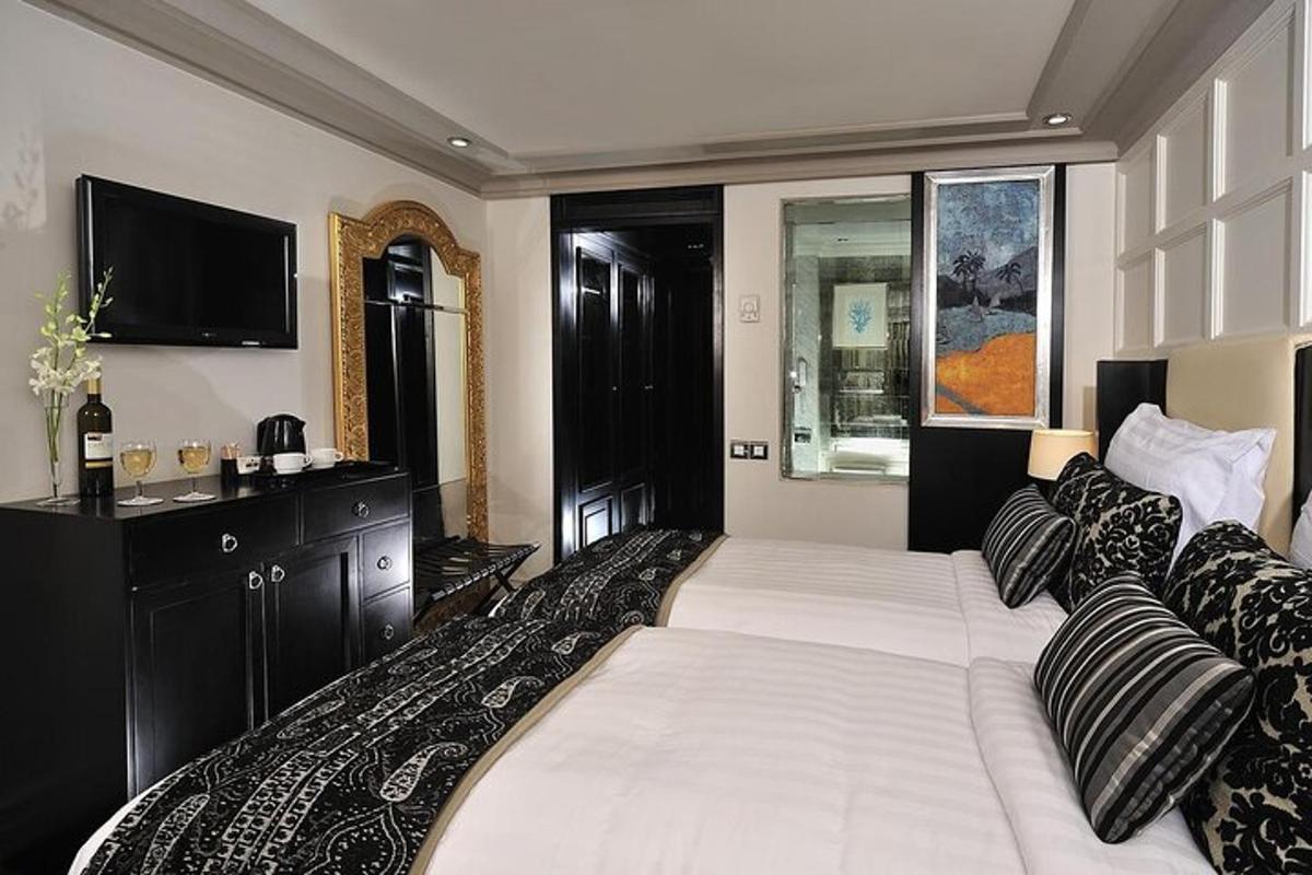 a bedroom with a large bed and a flat screen tv