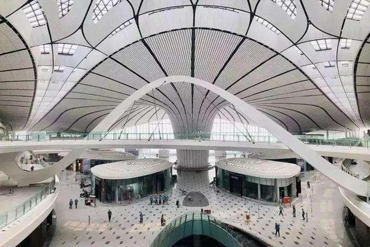 a large building with a domed ceiling with people in it