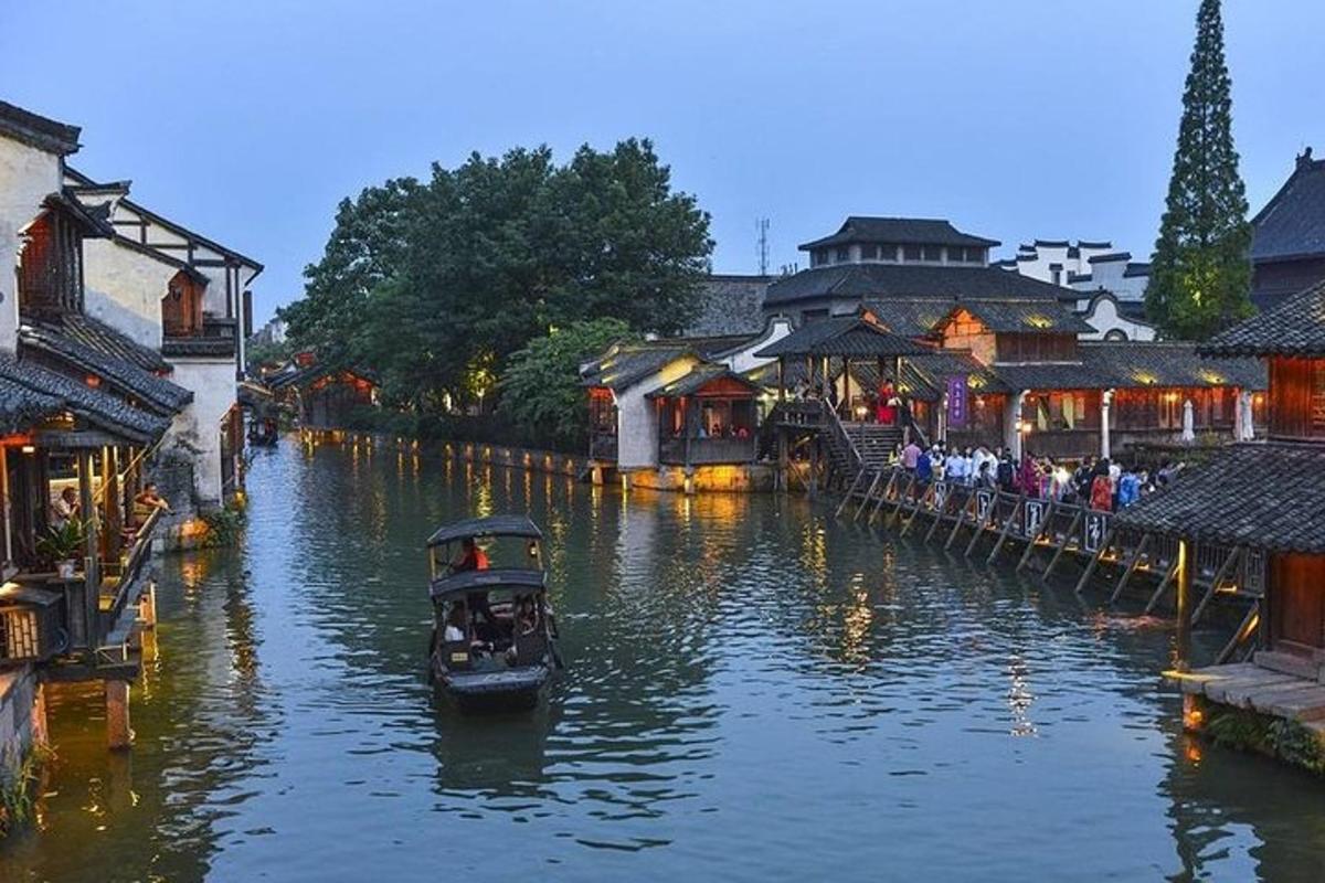a boat traveling down a river in a city