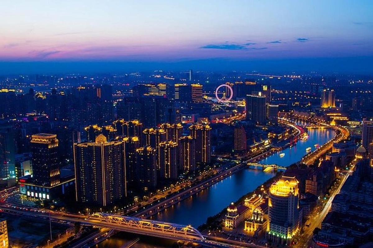 a city skyline at night with a river and buildings
