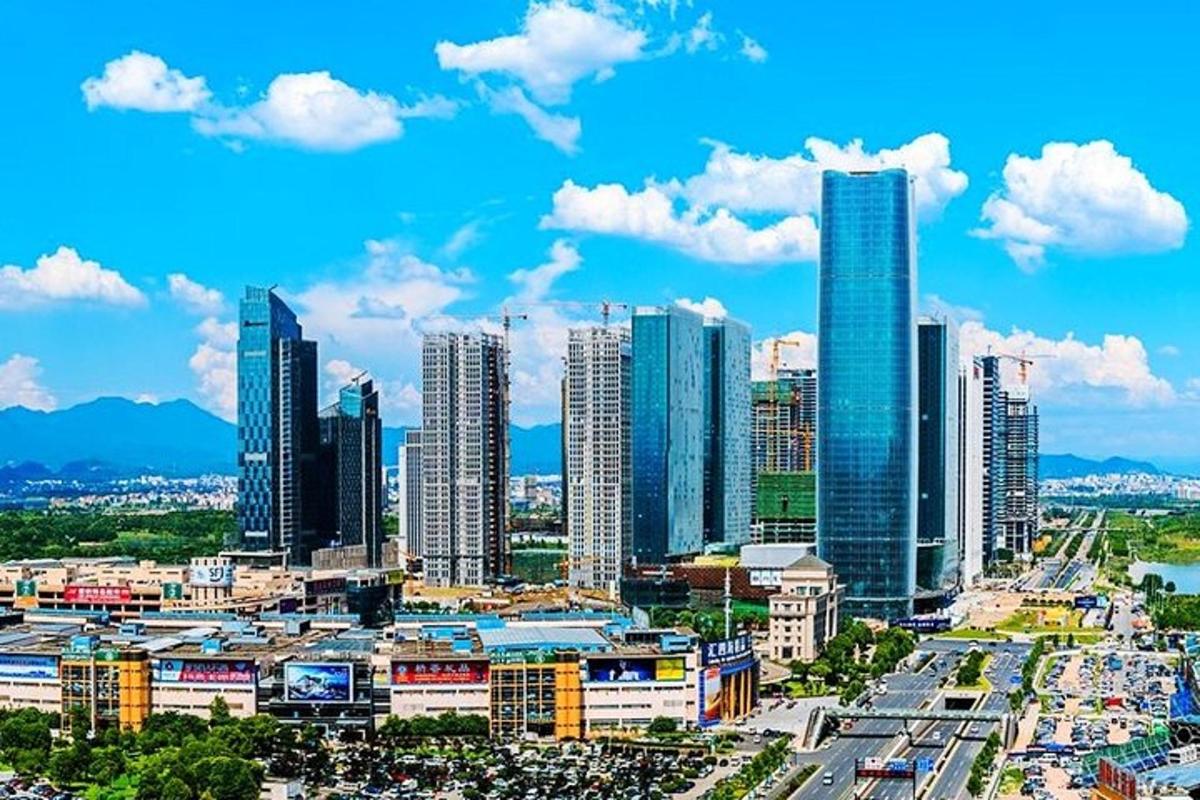 a city skyline with tall buildings and a blue sky