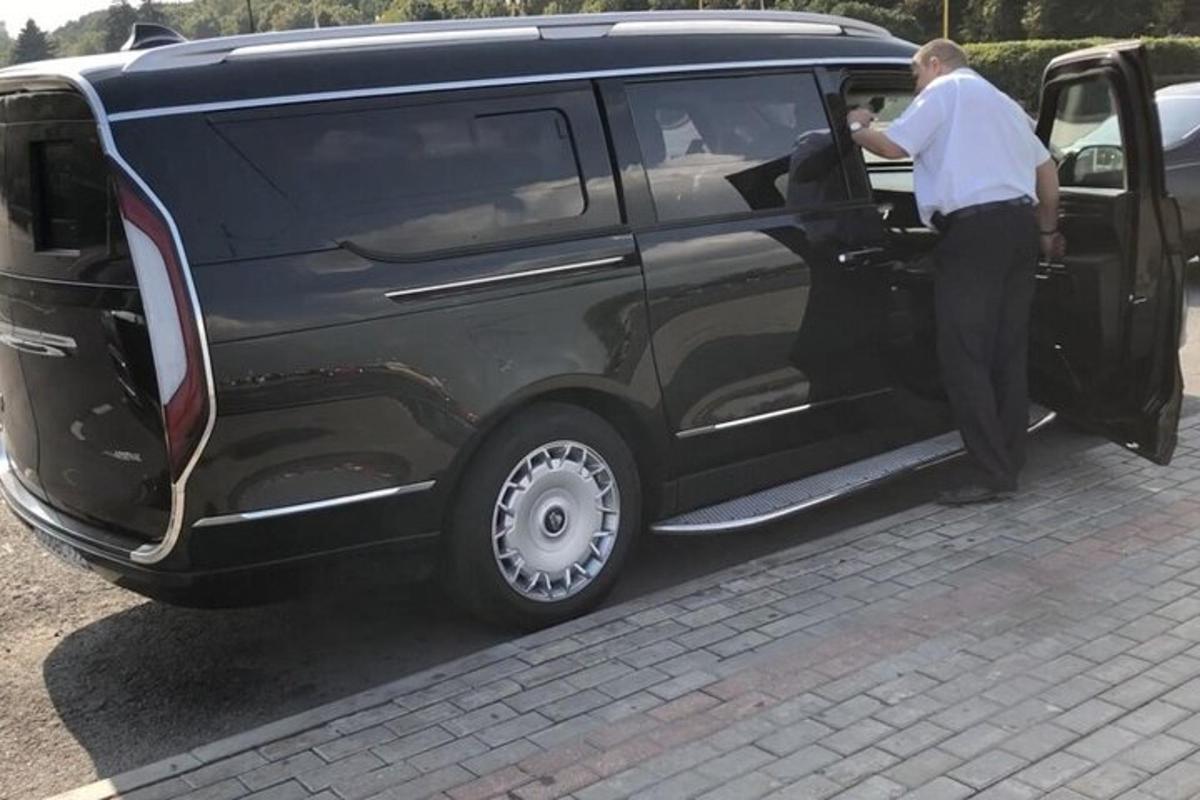 a man opening the door of a black van