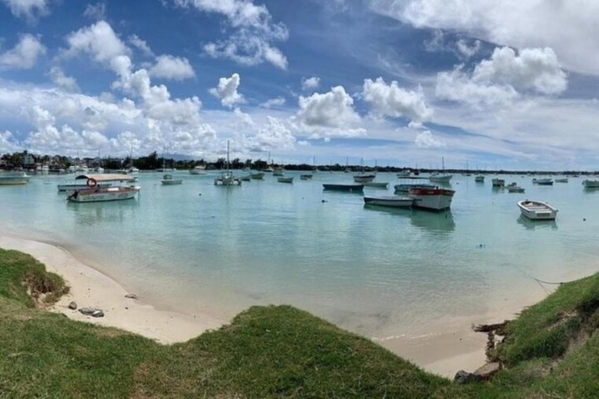 a group of boats in the water on a beach