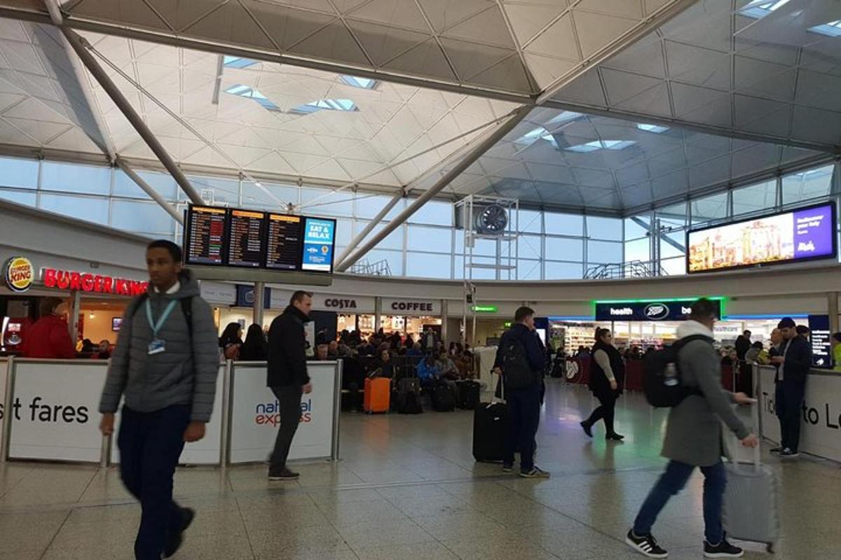 a group of people walking around an airport