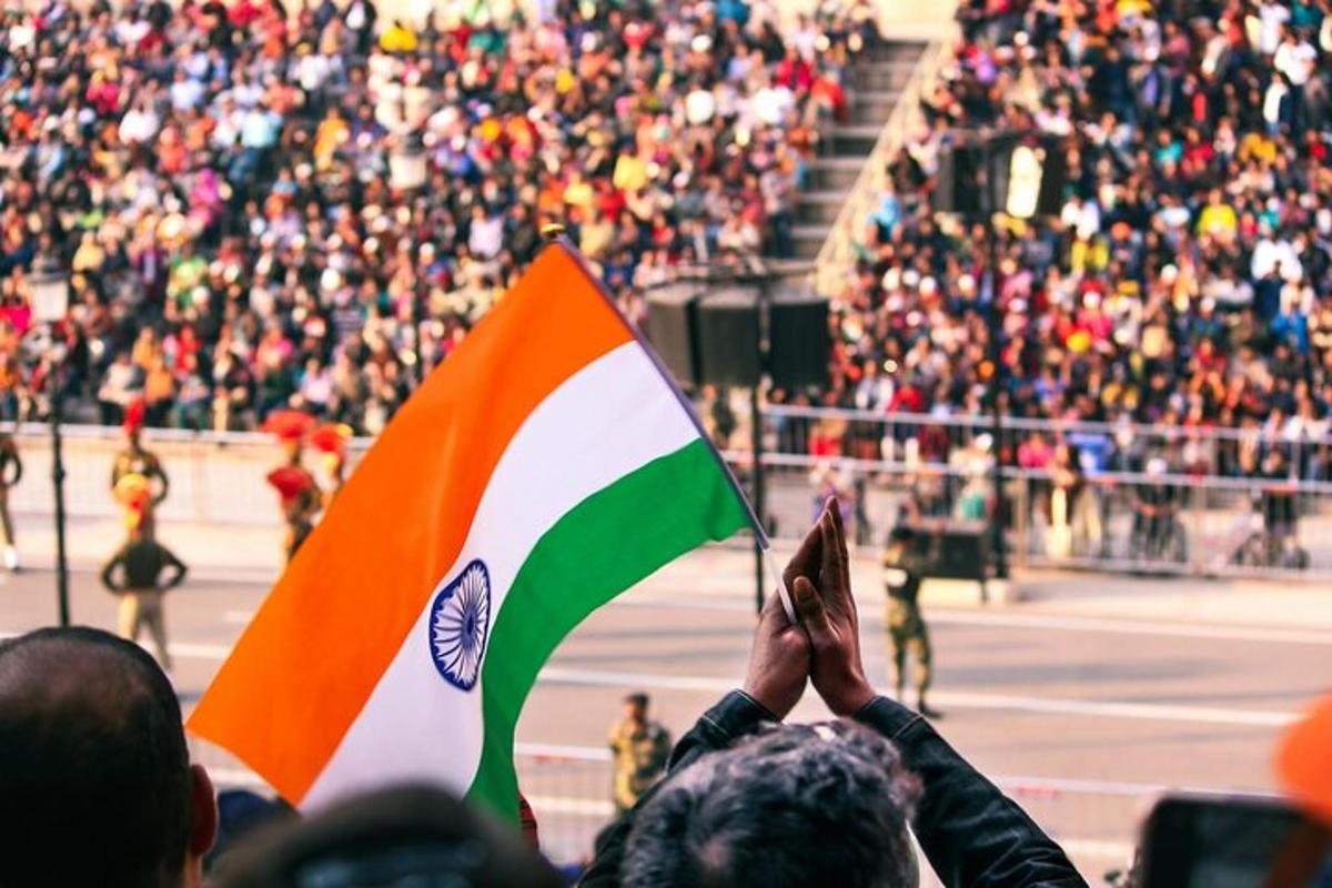 a group of people holding a flag in front of a crowd