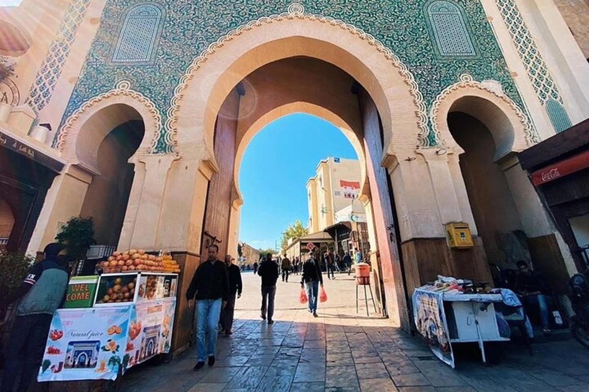 un grup de persones caminant per un arc en un mercat
