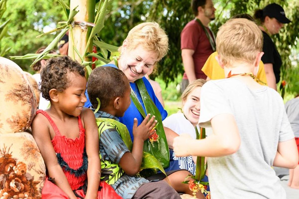a woman is talking to a group of children