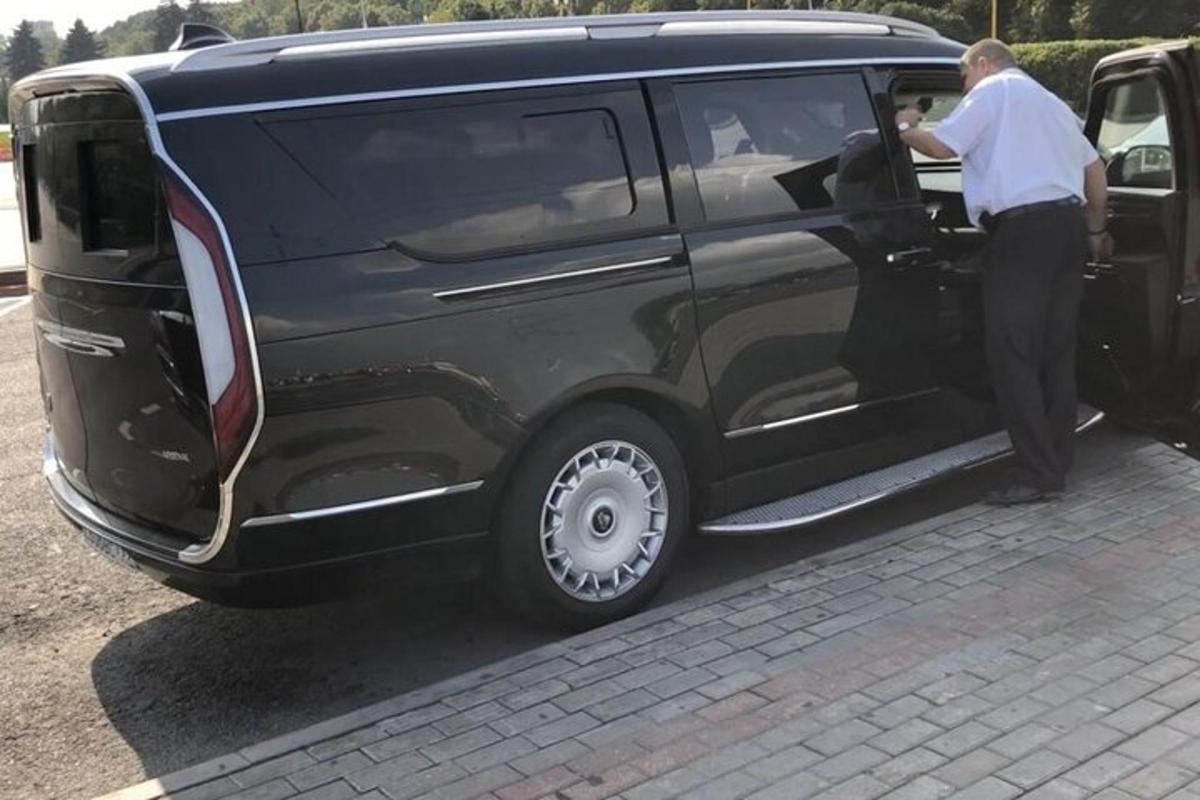 a man opening the door of a black van