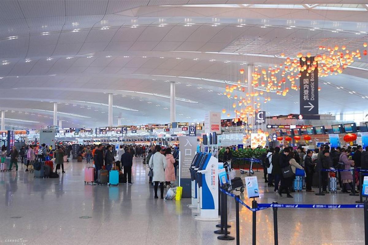 a group of people walking through an airport terminal