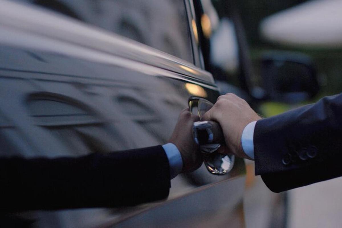 osoba fotící auto fotoaparátem