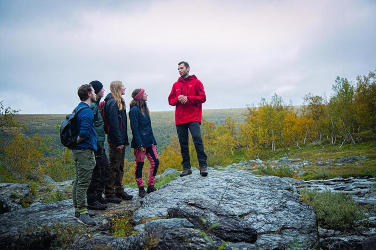a group of people standing on top of a rock
