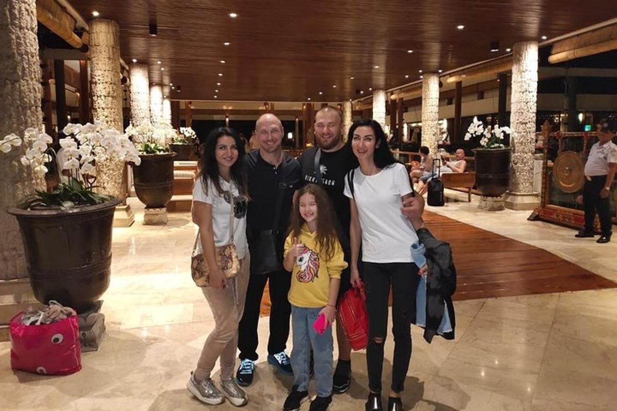 a group of people posing for a picture in a mall