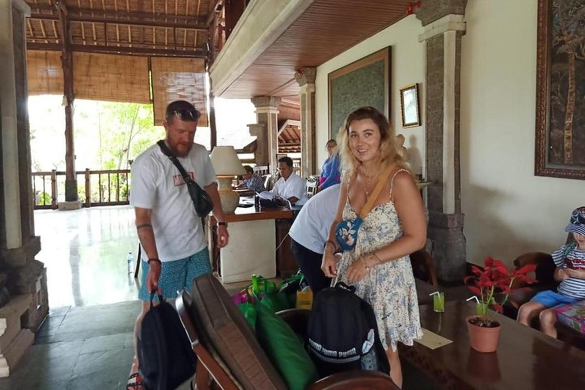 a woman standing next to a man with luggage