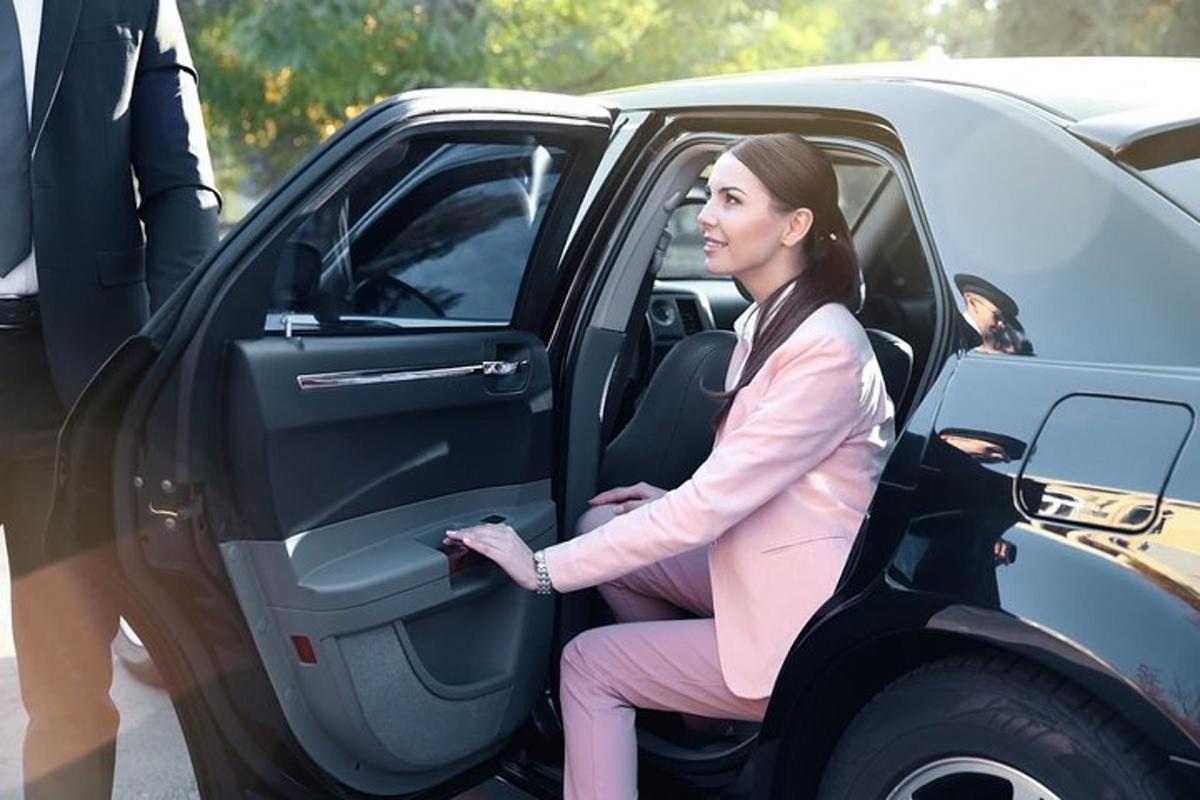 a woman sitting in the door of a car