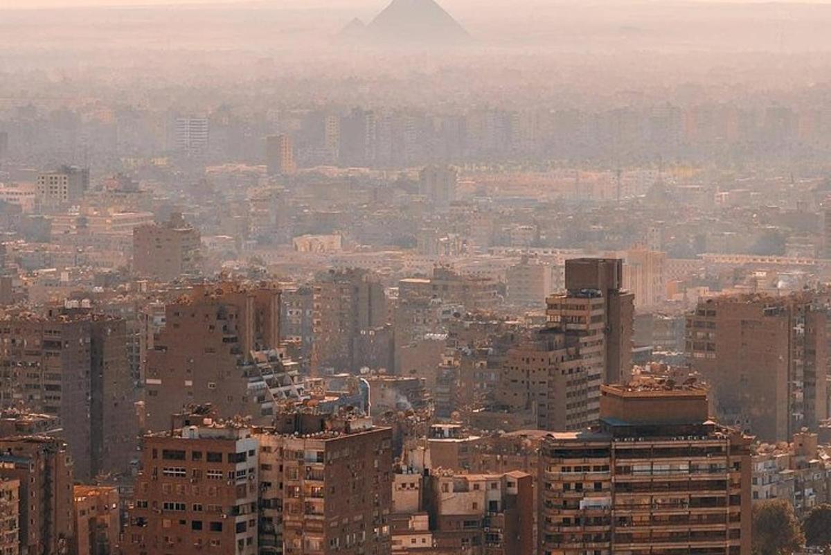 a view of a city with the pyramid in the background