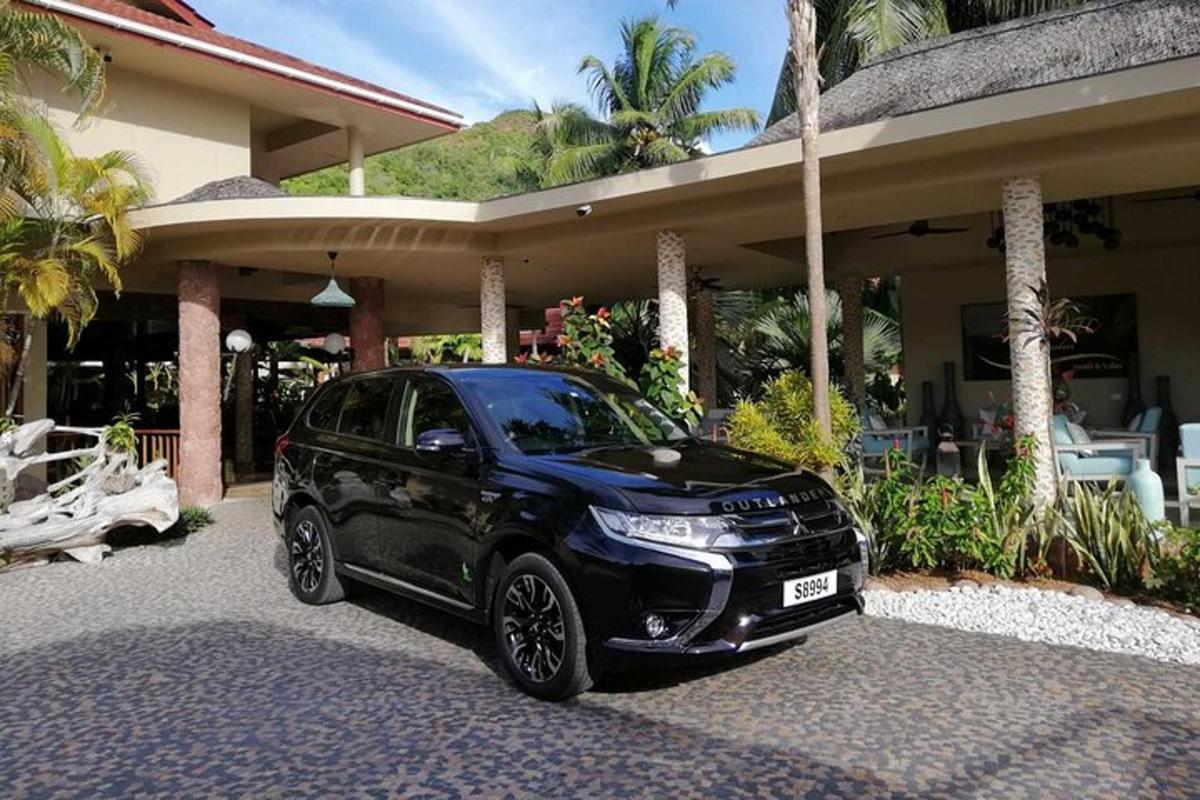 a black car parked in front of a house