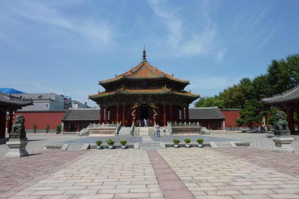 a large building with a pagoda in a courtyard