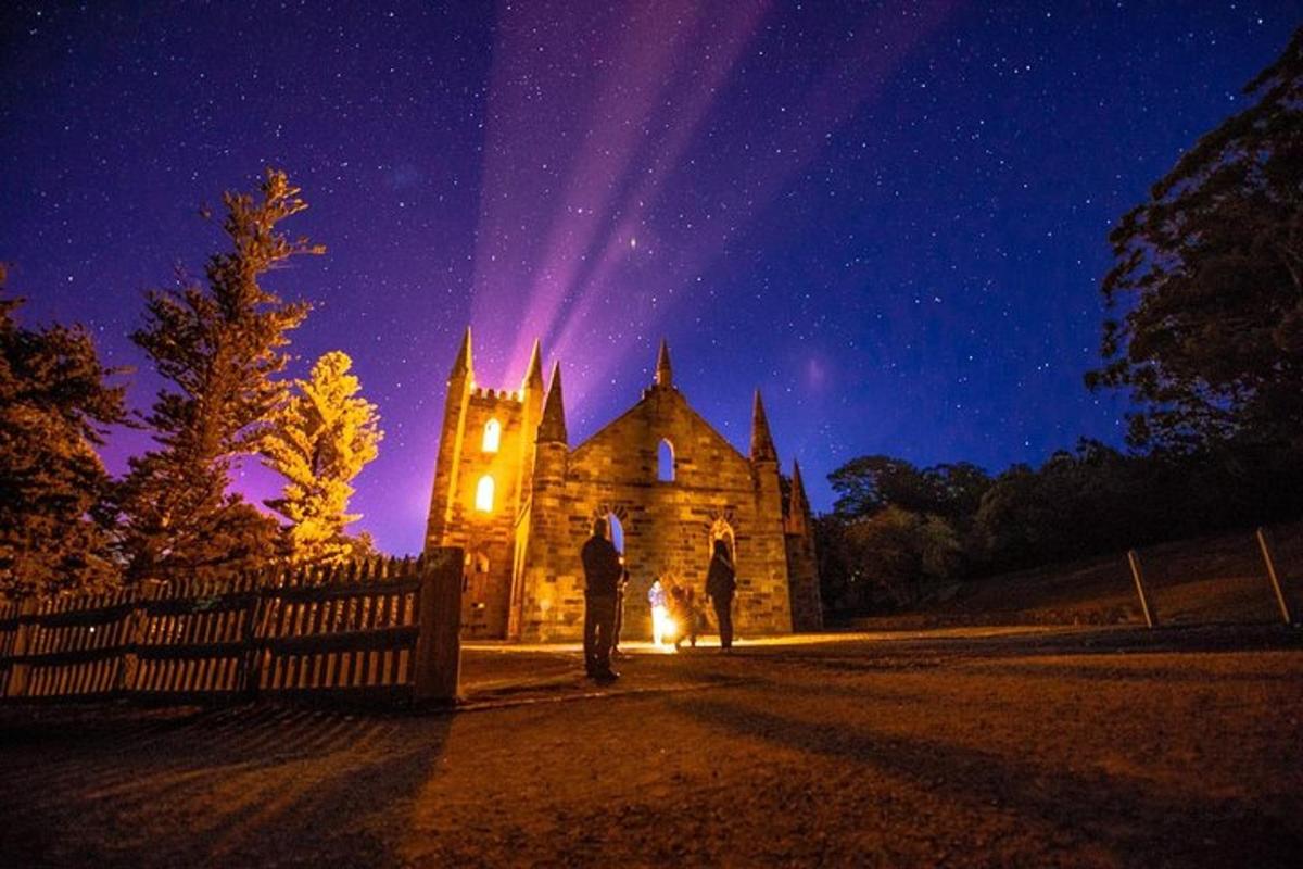 a couple standing in front of a church at night