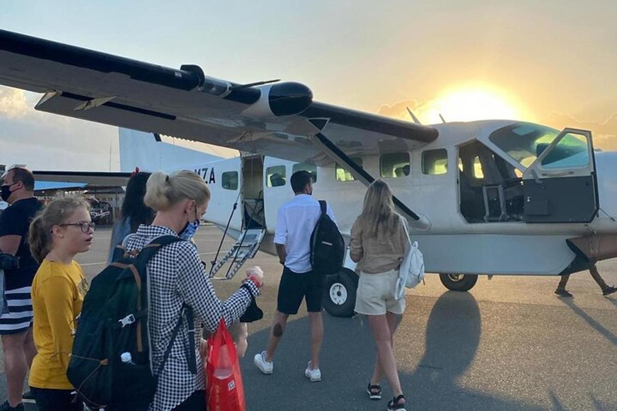 a group of people getting off of a small plane