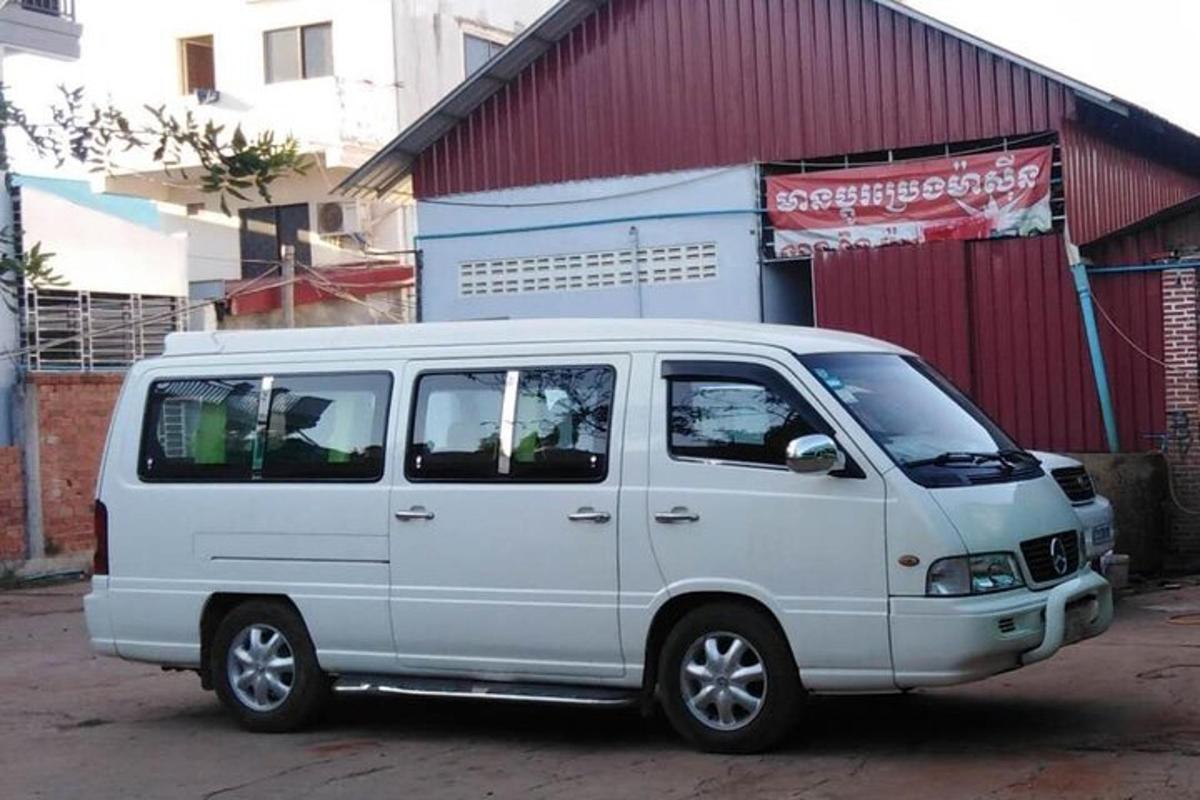 a white van parked in front of a building