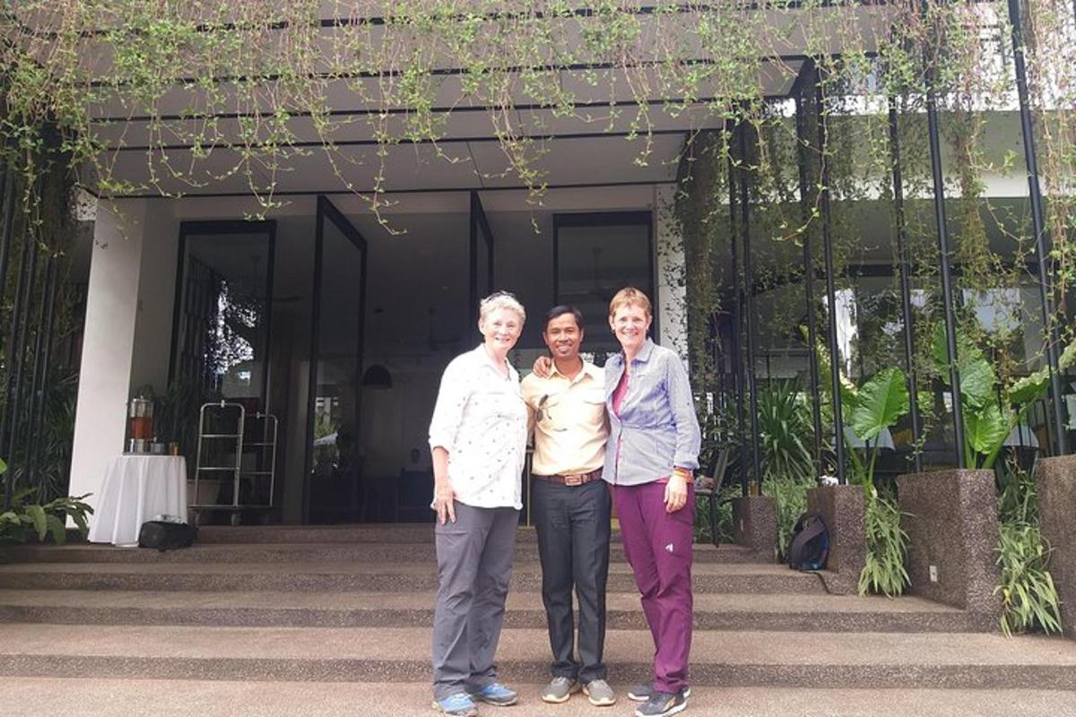 three women standing in front of a house