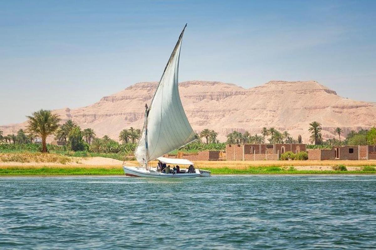 a boat with a large sail on the water